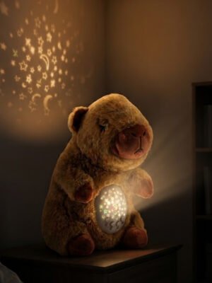 Peluche Capibara Soñadora con Proyector de estrellas y Música.